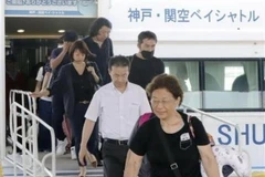 Hành khách di chuyển từ sân bay Kansai xuống xuồng cao tốc để sang sân bay Kobe ngày 5/9. (Ảnh: Kyodo/TTXVN)