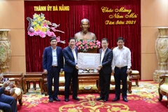 Trưởng Ban Nội chính Trung ương Phan Đình Trạc (thứ 2, từ trái sang) tặng quà lưu niệm cho Bí thư Thành ủy Đà Nẵng Nguyễn Văn Quảng (thứ 3, từ trái sang). (Ảnh: Quốc Dũng/TTXVN)