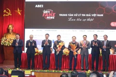 Phó Thủ tướng Vũ Đức Đam và Bộ trưởng Bộ Thông tin và Truyền thông Nguyễn Mạnh Hùng tặng hoa chúc mừng Khai trương Cổng thông tin tiếp nhận phản ánh và công bố tin giả và ra mắt đầu số tiếp nhận phản ánh tin giả 18008108. (Ảnh: Minh Quyết/TTXVN)