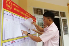 Người dân khu 9, phường Hồng Hà, thành phố Hạ Long, xem danh sách cử tri niêm yết tại nhà văn hóa khu. (Nguồn: Báo Quảng Ninh)