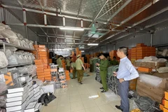 Lực lượng chức năng phát hiện kho hàng rộng hơn 500m2 chưa hàng chục nghìn sản phẩm túi nhái thương hiệu nổi tiếng. (Nguồn: Congthuong.vn)