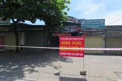 Lực lượng chức năng ở thành phố Vinh, Nghệ An tiến hành phong tỏa chợ Cửa Bắc nằm trên đường Lê Lợi do phát hiện ca dương tính SARS-CoV-2. (Ảnh: Nguyễn Văn Nhật/TTXVN)