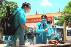 Sát khuẩn tay khi đến khu cách ly. (Ảnh: Đinh Tuấn/TTXVN)