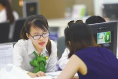 Giao dịch tại Vietcombank. (Ảnh: CTV/Vietnam+)