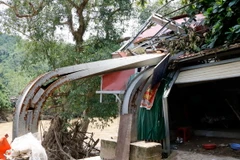 Cây cầu treo trung tâm của xã Phong Dụ Hạ, huyện Văn Yên (Yên Bái) bị lũ cuốn, chỉ còn sót lại mố sắt xiêu vẹo. (Ảnh: Việt Dũng/TTXVN)