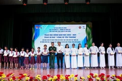 Trao học bổng Vừ A Dính cho các em học sinh là đồng bào dân tộc thiểu số, học sinh có hoàn cảnh khó khăn. (Ảnh: Hồng Đạt/TTXVN)