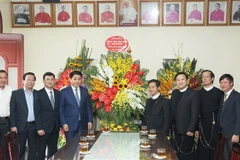 Chủ tịch Ủy ban Nhân dân thành phố Hà Nội Nguyễn Đức Chung tặng hoa, chúc mừng Lễ Giáng sinh Giáo xứ Thái Hà. (Ảnh: Lâm Khánh/TTXVN)