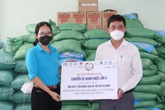 Bà Bùi Thị Cẩm Huyền, Phó Chủ nhiệm Câu lạc bộ Thiện Minh Sài Gòn trao 5 tấn nông sản và 150 túi an sinh tặng các gia đình có hoàn cảnh khó khăn do đại dịch. (Ảnh: TTXVN phát)