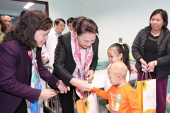 Chủ tịch Quốc hội Nguyễn Thị Kim Ngân tặng quà các bệnh nhân nhi đang điều trị tại bệnh viện. (Ảnh: Trọng Đức/TTXVN)