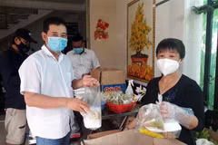 Anh Trần Phước Lành và vợ là chị Huỳnh Thị Thu Hằng chuẩn bị 130 phần cơm hỗ trợ người dân cách ly tập trung mỗi ngày. (Ảnh: TTXVN phát)
