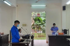 Đại diện Viện Kiểm sát Nhân dân tỉnh đọc cáo trạng buộc tội bị cáo Lê Hoàng Quang về tội 'Cố ý gây thương tích' tại phiên tòa. (Ảnh: TTXVN)