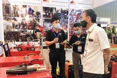 Doanh nghiệp giới thiệu sản phẩm dụng cụ cầm tay đến khách tham quan tại Vietnam Expo 18. (Ảnh: Mỹ Phương/TTXVN)