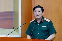 Đại tướng Ngô Xuân Lịch, Ủy viên Bộ Chính trị, Phó Bí thư Quân uỷ Trung ương, Bộ trưởng Bộ Quốc phòng, phát biểu khai mạc hội nghị. (Ảnh: Dương Giang/TTXVN)
