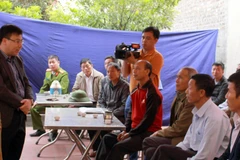 Phó Chủ tịch UBND huyện Yên Dũng Nguyễn Văn Thưởng trao đổi với nhân dân thôn Yên Hà về xử lý các vi phạm trong bình xét hộ nghèo. (Ảnh: Đồng Thúy/TTXVN)