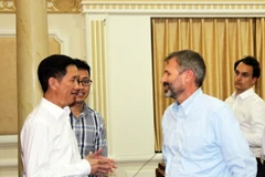Ông Trần Vĩnh Tuyến, Phó Chủ tịch UBND Thành phố Hồ Chí Minh (trái) trao đổi với ông Kyle Kelhofer, Giám đốc cao cấp của IFC. (Ảnh: Xuân Khu/TTXVN)