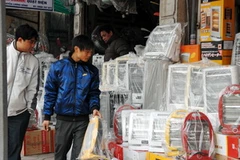 Khách hàng chọn mua thiết bị sưởi ấm tại một cửa hàng trên phố Nguyễn Lương Bằng, Hà Nội. (Ảnh: Danh Lam/TTXVN)