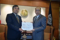 Ngoại trưởng Thái Lan Tovichakchaikul trao tấm séc trị giá 3 triệu baht cho Đại sứ Việt Nam Ngô Đức Thắng tại trụ sở Bộ Ngoại giao Thái Lan. (Ảnh: Ngọc Tiến/Vietnam+) 