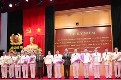 Thượng tướng Tô Lâm, Bộ trưởng Bộ Công an tặng Bằng khen của Bộ trưởng Bộ Công an cho các giáo sư năm 2016. (Ảnh: Phương Hoa/TTXVN) 