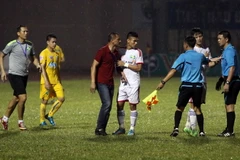 HLV Ngô Quang Trường phản ứng trọng tài vì quyết định thổi phạt penalty. (Ảnh: Thanh Tùng/TTXVN)