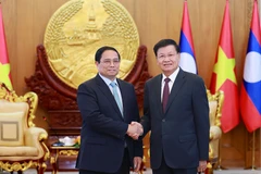 Thủ tướng Phạm Minh Chính hội kiến Tổng Bí thư, Chủ tịch nước Lào Thongloun Sisoulith. (Ảnh: Dương Giang/TTXVN)