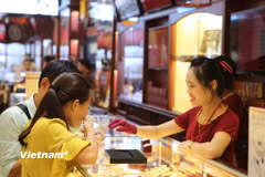 Khách hàng giao dịch vàng. (Ảnh: Vietnam+)