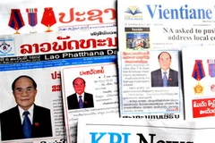 Báo chí Lào đăng tin bài về chuyến thăm của Chủ tịch Quốc hội Nguyễn Sinh Hùng. (Ảnh: Hoàng Chương/Vietnam+)