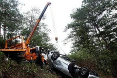 Lực lượng cứu hộ đang đưa chiếc xe lên mặt đường. (Ảnh: Nguyễn Dũng/TTXVN)