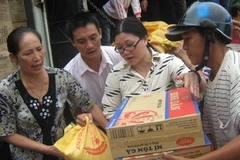 Người dân nhận hàng cứu trợ. (Ảnh: Phan Đình Quân/TTXVN).