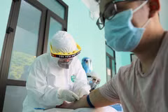 Nhân viên y tế lấy mẫu máu để xét nghiệm nhanh cho người dân tại Trạm Y tế phường Dịch Vọng, quận Cầu Giấy. (Ảnh: Thanh Tùng/TTXVN)