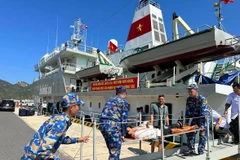 Lực lượng hải quân đưa bệnh nhân từ tàu 571 đưa bệnh nhân lên đất liền. (Ảnh: T.G/Vietnam+)