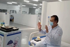 Bệnh nhân mắc COVID-19 nhận cơm từ robot tại Trung tâm Hồi sức tích cực điều trị bệnh nhân COVID-19 của Bệnh viện Trung ương Huế tại Thành phố Hồ Chí Minh. (Ảnh: PV/Vietnam+)