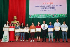 Thứ trưởng Bộ Y tế Nguyễn Thanh Long trao Bằng khen cho nhà báo Lê Quốc Minh, Phó Tổng giám đốc TTXVN. (Ảnh: Thành Đạt/TTXVN)