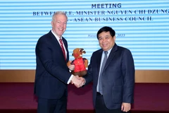 Bộ trưởng Nguyễn Chí Dũng trao quà lưu niệm cho ông Ted Osius, Chủ tịch Hội đồng USABC. (Ảnh: CTV/Vietnam+)