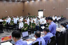 Đại diện Viện Kiểm sát công bố bản cáo trạng các bị cáo tại phiên tòa xét xử sơ thẩm. (Ảnh: Phạm Kiên/TTXVN)