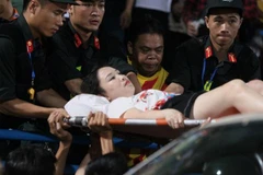 Nữ cổ động viên được đưa đến viện. (Ảnh: Vietnam+)