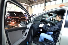 Nhân viên đăng kiểm kiểm tra hệ thống phanh xe. (Ảnh: Huy Hùng/TTXVN)