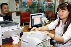 Điều chỉnh tỷ giá sẽ giảm bớt tình trạng găm giữ ngoại tệ