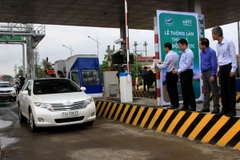 Một trong những phương tiện đầu tiên lưu thông qua Trạm BOT Quảng Trị thu phí tự động. (Ảnh: Nguyên Lý/TTXVN)