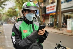 Anh Trần Đức Lượng – Tài xế đặc biệt của Gojek. (Ảnh: VC/Vietnam+)