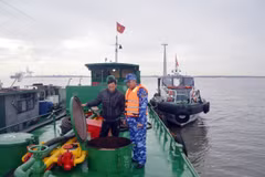 Lực lượng chức năng tạm giữ tàu và số dầu không rõ nguồn gốc. (Ảnh: TTXVN phát)