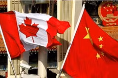 Quốc kỳ Canada (trái) và Quốc kỳ Trung Quốc tại Bắc Kinh. (Nguồn: South China Morning Post/TTXVN)