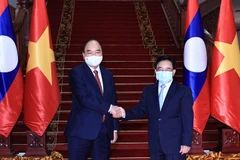 Chủ tịch nước Nguyễn Xuân Phúc hội kiến Thủ tướng Lào Phankham Viphavanh. (Ảnh: Thống Nhất/TTXVN)