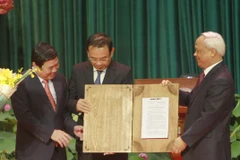 Ông Uông Chu Lưu, Phó Chủ tịch Quốc hội, trao Nghị quyết của Ủy ban Thường vụ Quốc hội về việc sắp xếp các đơn vị hành chính và thành lập thành phố Thủ Đức trực thuộc Thành phồ Hồ Chí Minh tại lễ công bố. (Ảnh: Thanh Vũ/TTXVN)