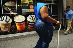 Tình trạng béo phì ngày càng trở nên phổ biến do thói quen ăn uống nhiều chất béo, đường. (Ảnh: AFP)