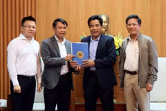 Tổng Giám đốc TTXVN Nguyễn Đức Lợi trao quà hỗ trợ đồng bào bị thiệt hại do mưa bão cho Phó Bí thư Thường trực Tỉnh ủy Quảng Nam Lê Văn Dũng. (Ảnh: Trịnh Bang Nhiệm/TTXVN)