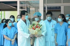 Tặng hoa các y, bác sỹ trực tiếp điều trị bệnh nhân mắc COVID-19 tại bệnh viện Đà Nẵng. (Ảnh: Văn Dũng/TTXVN)