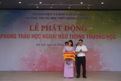 Ông Trần Trọng Hưng, Phó trưởng Ban Đề án Ngoại ngữ quốc gia 2020 tặng sách ngoại ngữ cho Trường Trung học phổ thông Yên Hòa. (Ảnh: PV/Vietnam+)