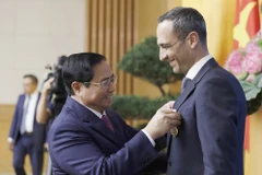 Thủ tướng Phạm Minh Chính trao Huy chương Hữu nghị của Chủ tịch nước cho ông John Paul Pullicino Said Anthony, nguyên Tổng giám đốc Công ty TNHH Pfizer Việt Nam. (Ảnh: Dương Giang/TTXVN)