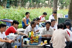 Một quán trà đá trước cổng Đại học Thủy lợi thu hút rất nhiều phụ huynh ngồi uống nước. (Ảnh: Kỳ Dương/Vietnam+)