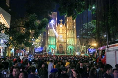 Đêm Giáng sinh trùng đúng vào dịp Chủ Nhật ngày nghỉ nên ngay từ chập tối, hàng vạn người dân Thủ đô đã đổ về các khu vực diễn ra lễ hội như Nhà thờ lớn, phố đi bộ Hồ Gươm. (Ảnh: Minh Sơn/Vietnam+)